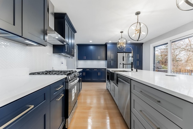 kitchen with light hardwood / wood-style flooring, dishwasher, range with gas stovetop, decorative light fixtures, and a chandelier