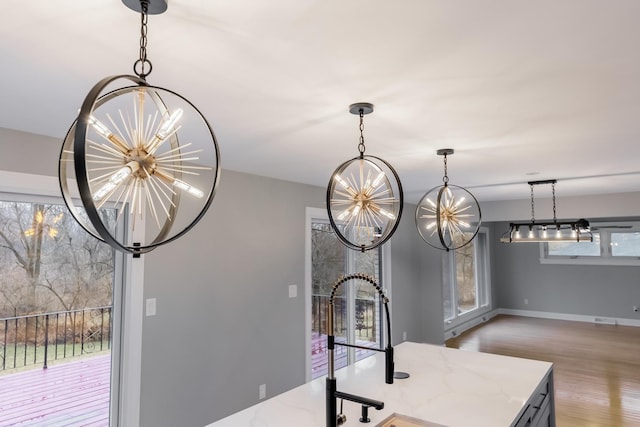 room details with hardwood / wood-style floors and a chandelier