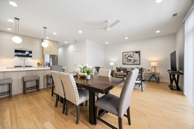 dining space featuring ceiling fan and light hardwood / wood-style floors