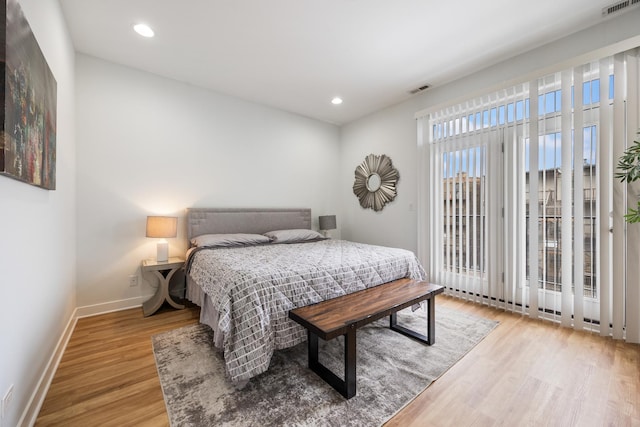 bedroom with hardwood / wood-style flooring and access to outside