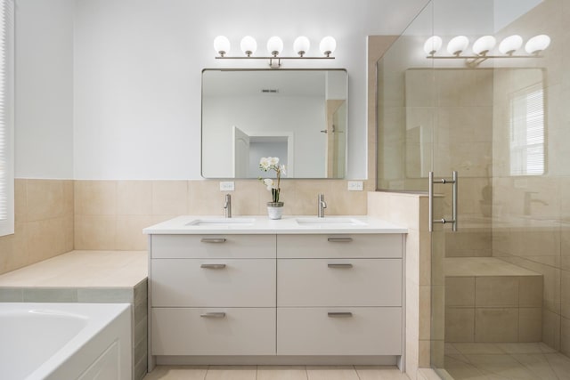 bathroom featuring tile patterned floors, vanity, and separate shower and tub