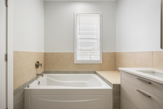 bathroom with vanity and a tub