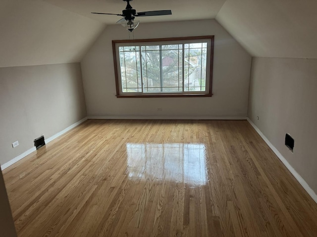 bonus room with vaulted ceiling, ceiling fan, and light hardwood / wood-style floors