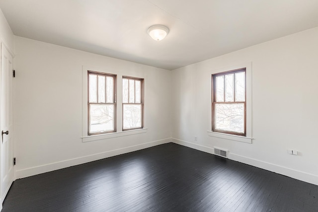 spare room featuring dark hardwood / wood-style floors