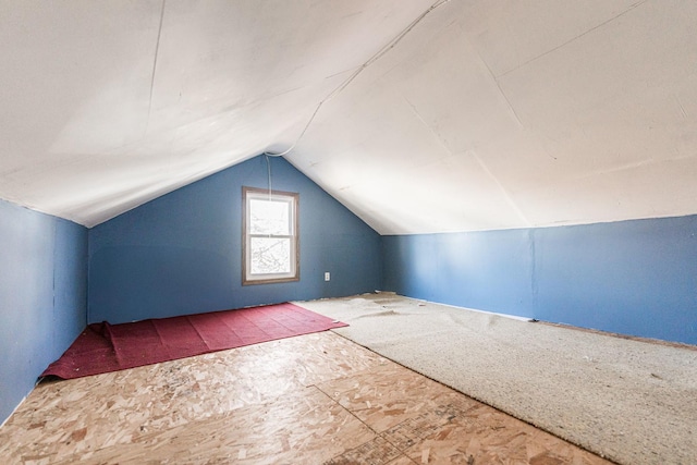 additional living space featuring vaulted ceiling