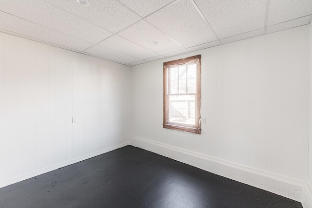 unfurnished room with a paneled ceiling