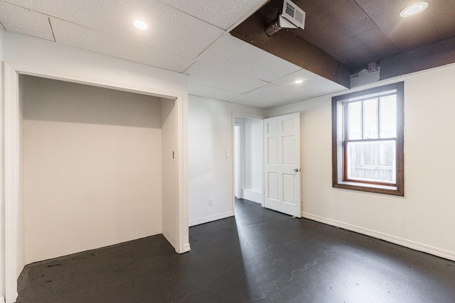 basement with a paneled ceiling