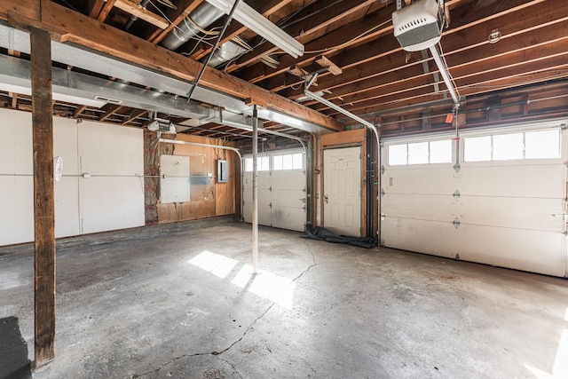 garage featuring a garage door opener and electric panel