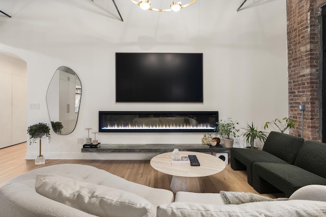 living room with hardwood / wood-style floors and a notable chandelier