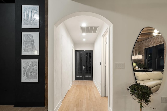 hall featuring french doors and light hardwood / wood-style flooring