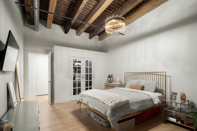 bedroom featuring light hardwood / wood-style flooring, wooden ceiling, french doors, and beamed ceiling