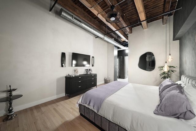 bedroom with wood ceiling, light hardwood / wood-style floors, a high ceiling, and beamed ceiling