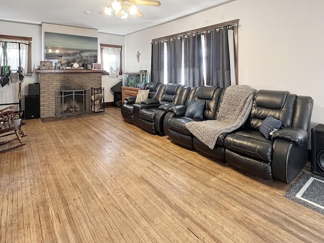 living room with a fireplace and light wood-type flooring