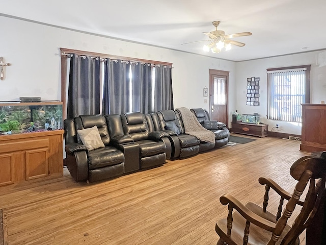 living room featuring light hardwood / wood-style flooring and ceiling fan