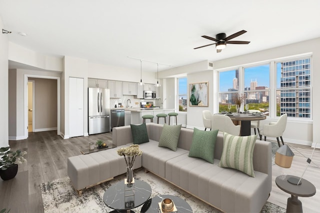 5 E 14th Pl Unit 801, Chicago, IL 60605 - living area with baseboards, a ceiling fan, and light wood-style floors