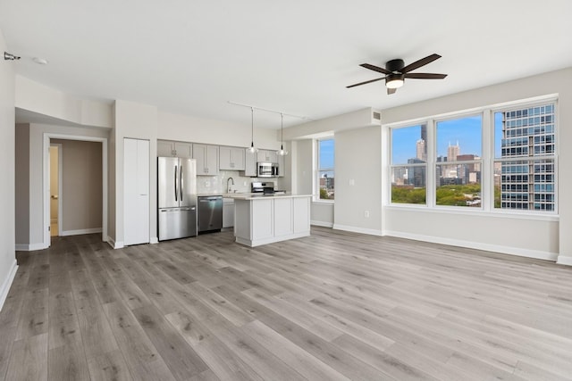 5 E 14th Pl Unit 801, Chicago, IL 60605 - kitchen featuring appliances with stainless steel finishes, a sink, open floor plan, light countertops, and a ceiling fan