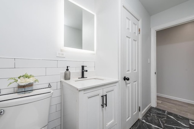 bathroom featuring vanity and toilet