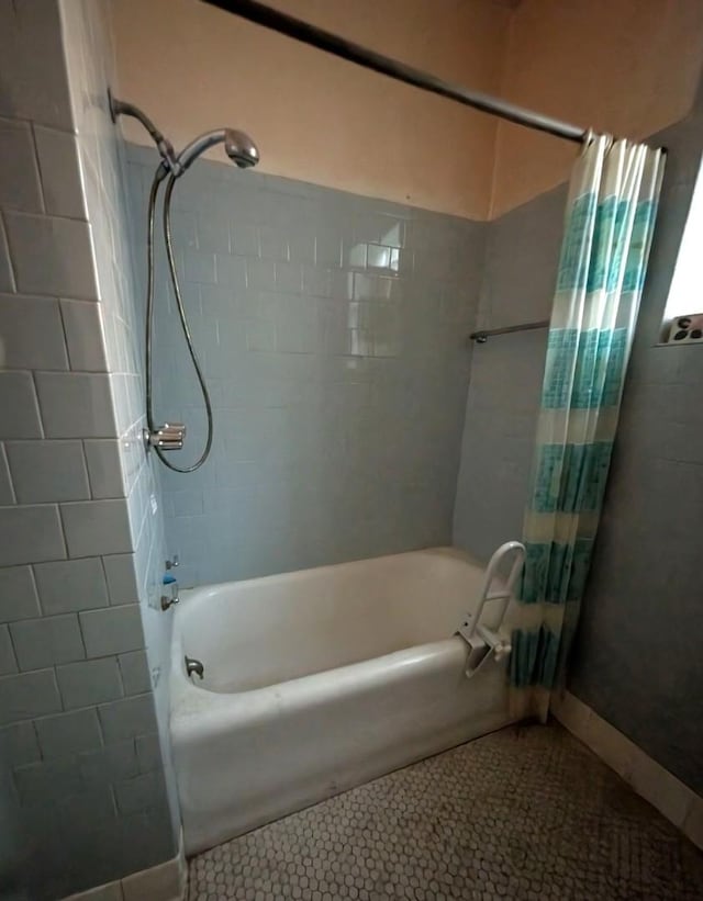 bathroom featuring tile patterned flooring and shower / bath combo with shower curtain