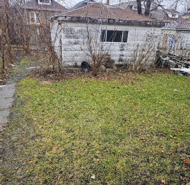 view of side of home featuring a yard