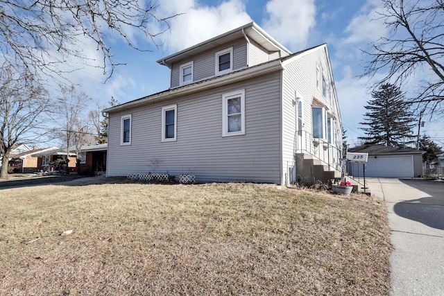 view of side of property featuring a garage, an outbuilding, and a lawn