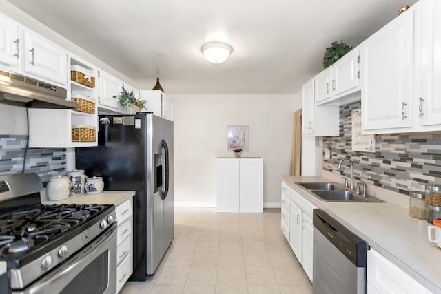 kitchen featuring sink, white cabinetry, light tile patterned floors, stainless steel appliances, and backsplash