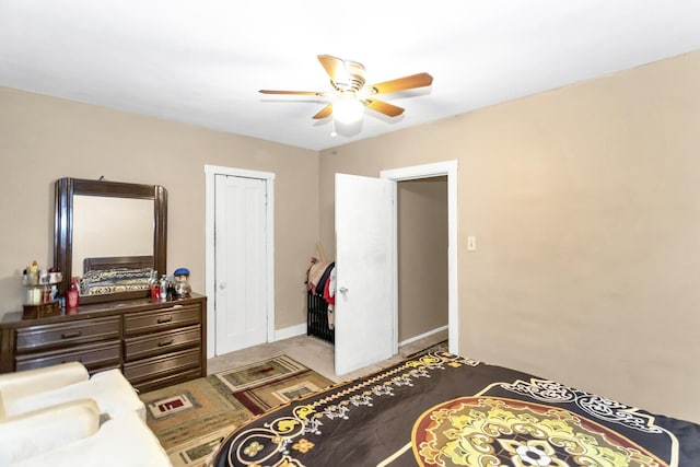 carpeted bedroom featuring ceiling fan and a closet