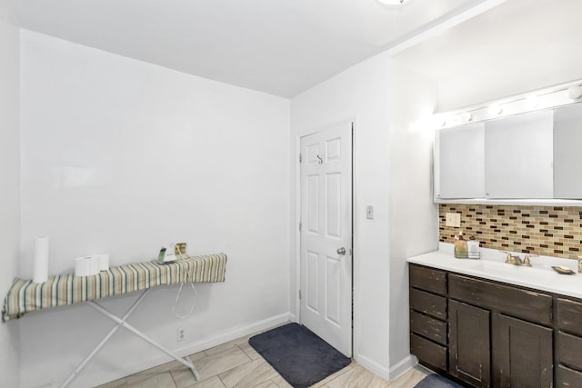 bathroom with tasteful backsplash, vanity, and tile patterned floors