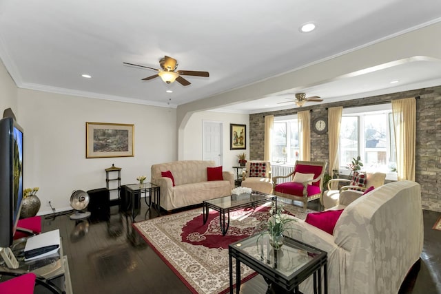 living room featuring hardwood / wood-style flooring, crown molding, and ceiling fan