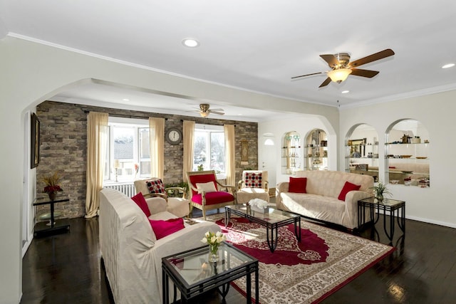 living room featuring dark wood-type flooring, ceiling fan, and ornamental molding