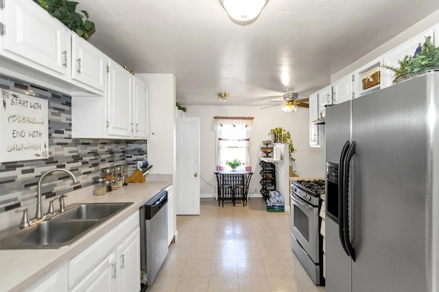 kitchen featuring sink, white cabinetry, ceiling fan, stainless steel appliances, and backsplash