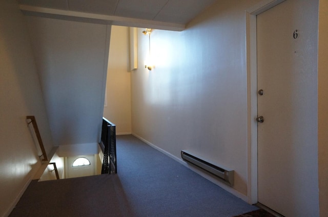 corridor featuring an upstairs landing, carpet floors, and a baseboard radiator