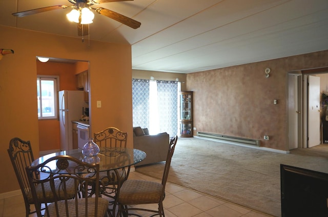 dining space featuring light tile patterned floors, a baseboard heating unit, light colored carpet, and ceiling fan