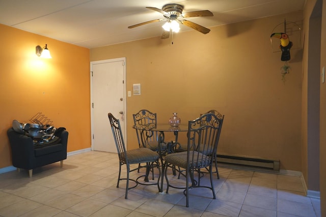 dining space featuring a baseboard heating unit, light tile patterned flooring, a ceiling fan, and baseboards