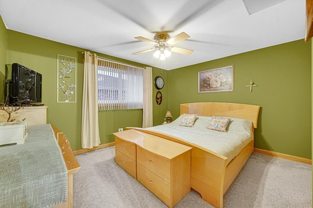 bedroom featuring light colored carpet and ceiling fan