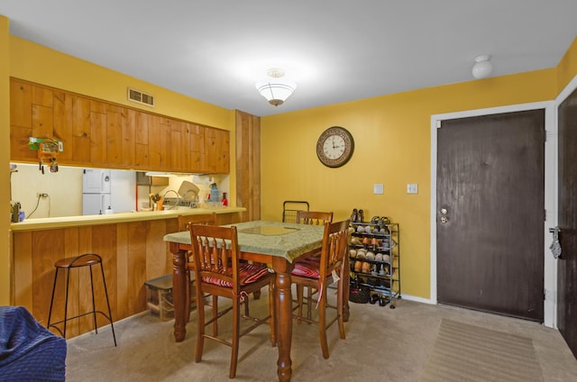 dining room featuring light colored carpet