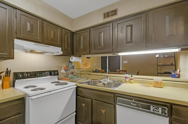 kitchen featuring white appliances, sink, and dark brown cabinets