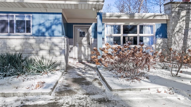 view of snow covered property entrance