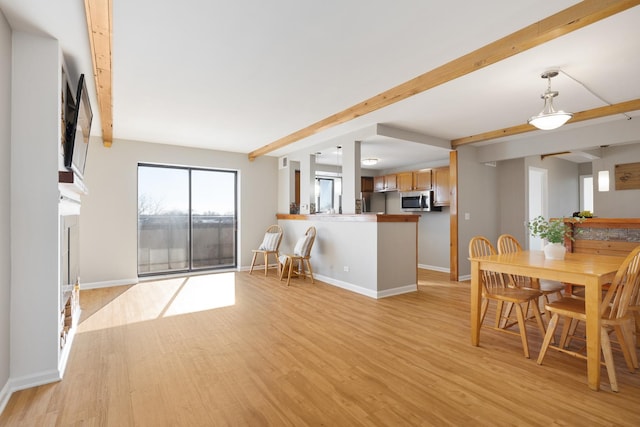 interior space featuring beam ceiling and light hardwood / wood-style floors