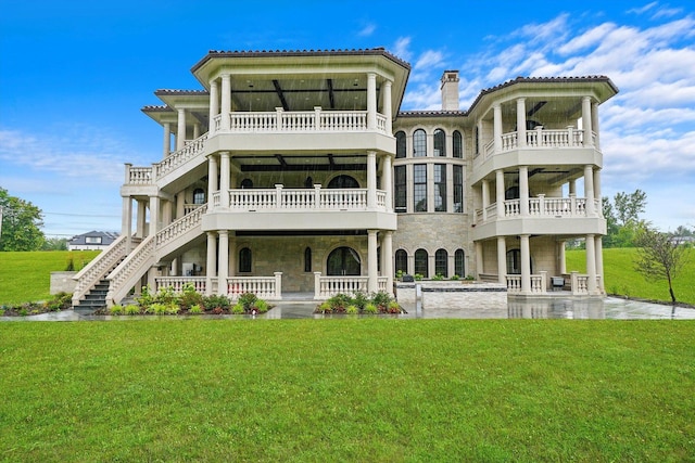 rear view of house featuring a yard and a porch