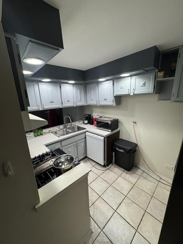 kitchen featuring white cabinetry, sink, and light tile patterned floors