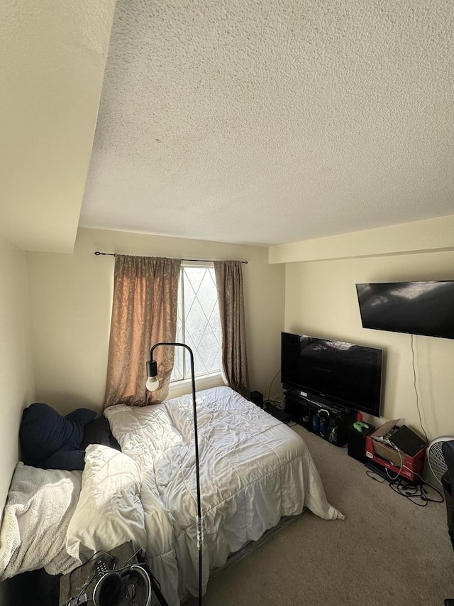 bedroom with a textured ceiling and carpet