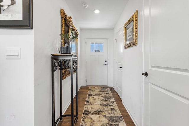 doorway to outside with dark wood-style floors