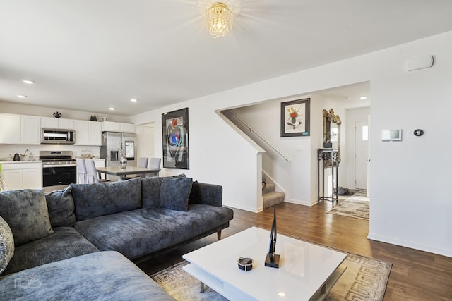 living area featuring stairs, baseboards, dark wood-style flooring, and recessed lighting