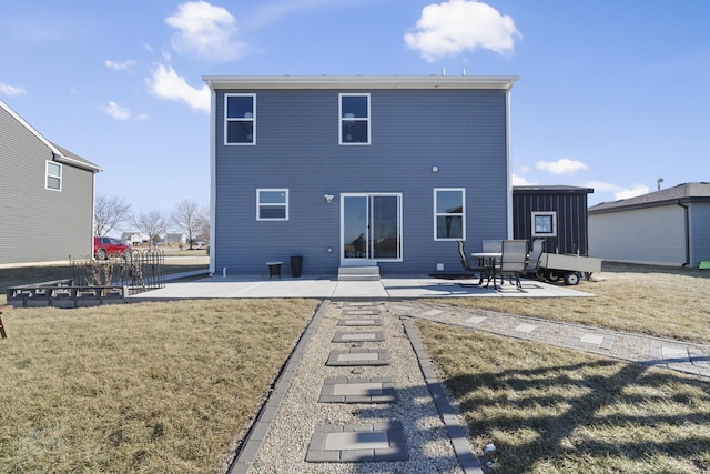 back of property with a lawn and a patio