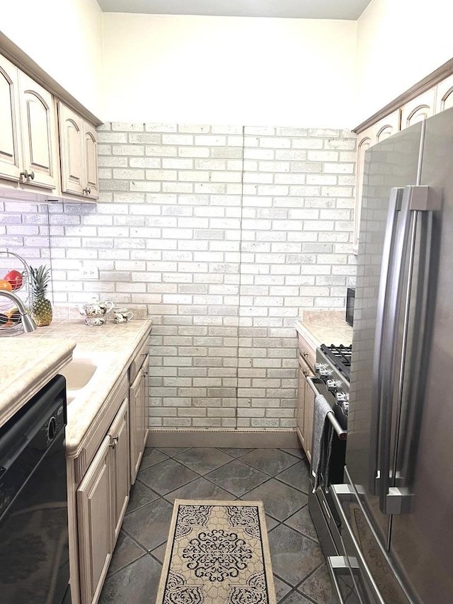 kitchen featuring stainless steel appliances, brick wall, and light brown cabinets