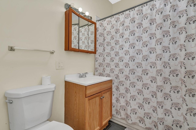 bathroom featuring vanity, walk in shower, and toilet