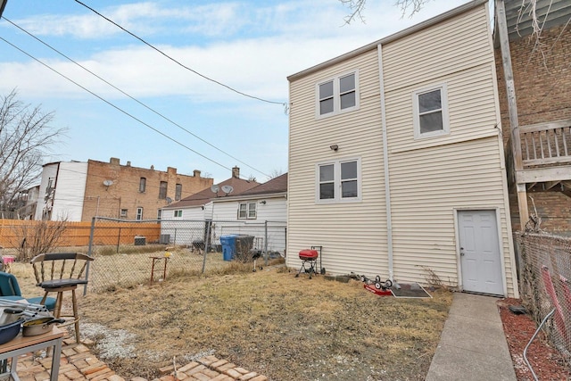 rear view of house with a yard