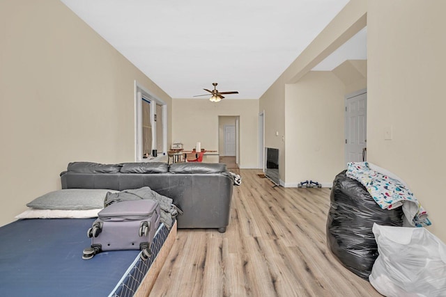 living room with ceiling fan and light wood-type flooring