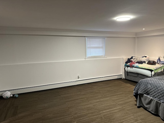 bedroom featuring a baseboard radiator, ornamental molding, and dark carpet