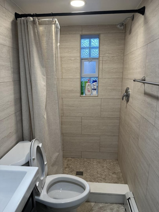 bathroom featuring a baseboard heating unit, a shower with curtain, sink, and toilet